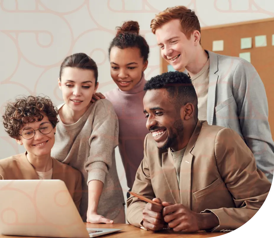 A group of people looking at a laptop.