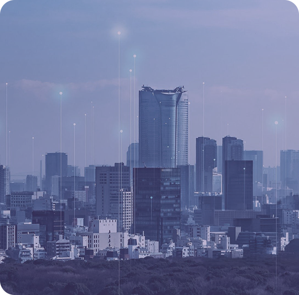 A group of people sitting around a table working on a laptop.