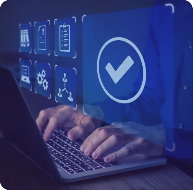 A group of people sitting around a table working on a laptop.