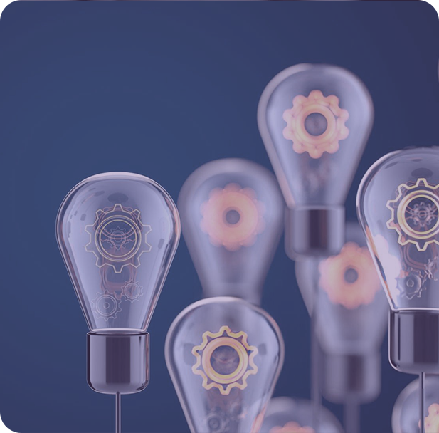 A group of people sitting around a table working on a laptop.